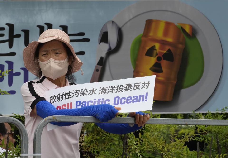 A South Korean fisherwoman participates in a rally against the planned release of treated radioactive water from the wrecked Fukushima nuclear power plant, in front of the National Assembly in Seoul, South Korea, Monday, June 12, 2023. (AP Photo/Ahn Young-joon)