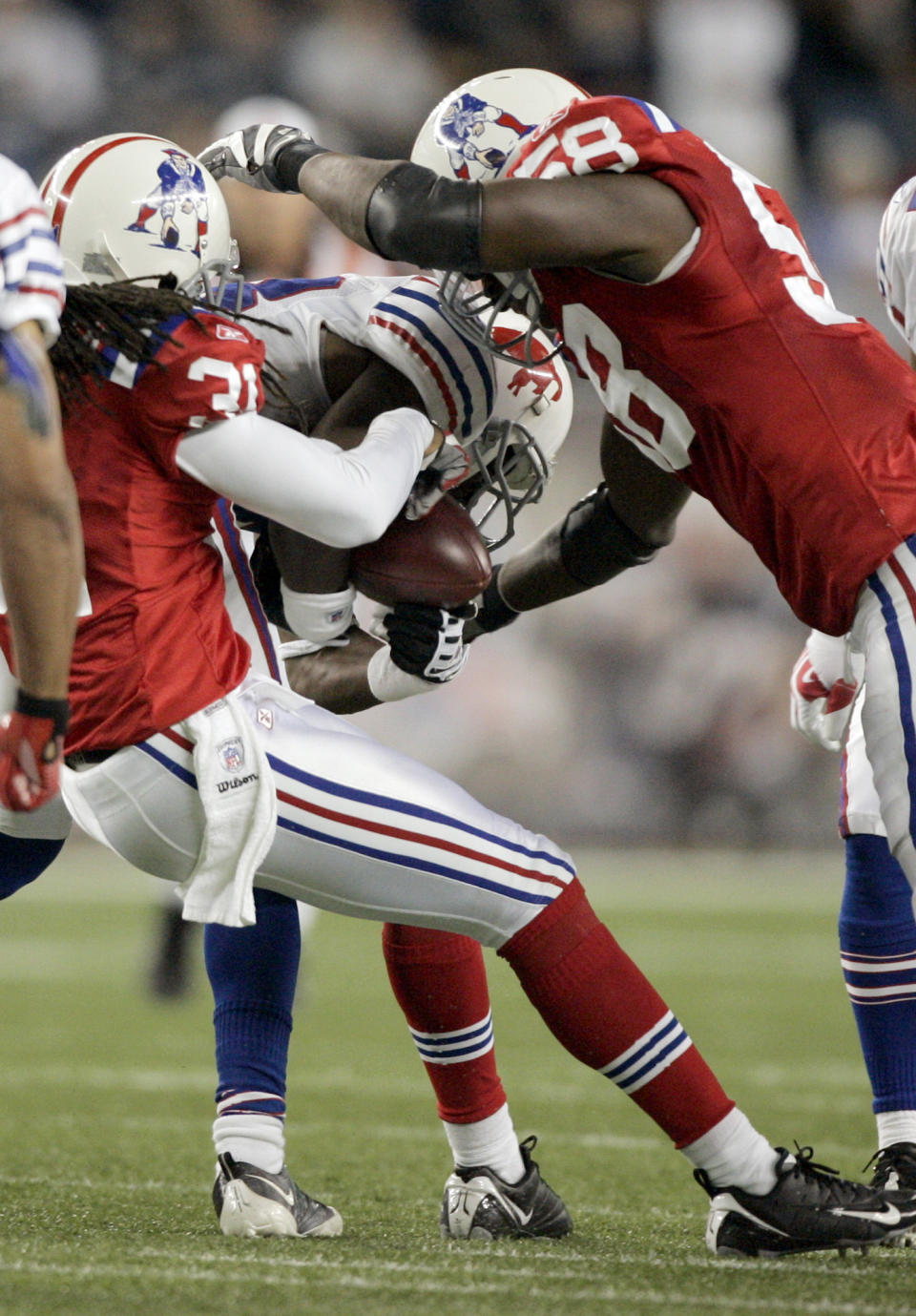 FILE - New England Patriots safety Brandon Meriweather (31) strips the ball from Buffalo Bills cornerback Leodis McKelvin, center, for a fumble as New England Patriots linebacker Pierre Woods (58) helps with the tackle in the fourth quarter during an NFL football game, Monday, Sept. 14, 2009, in Foxborough, Mass. The Patriots recovered the ball and went on to win the game, 25-24. Bill Belichick and the New England Patriots dominated the Buffalo Bills from 2000 to 2019, it was difficult to dub it a rivalry. (AP Photo/Steven Senne, File)