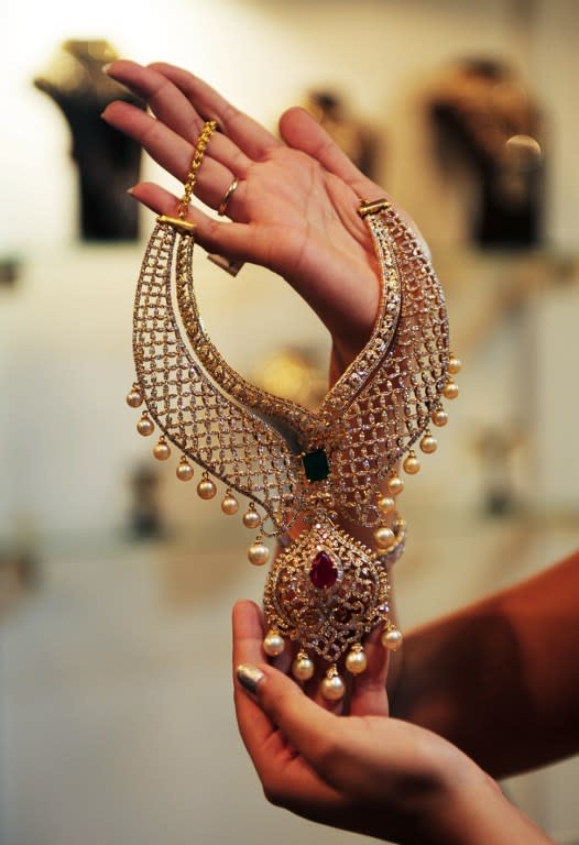 <p>An Indian model displays a dimond necklace valued at approximately $18,000 during a wedding expo in Chennai on June 4, 2016. </p>