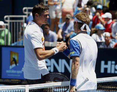 Milos Raonic (L) of Canada shakes hands with Daniel Gimeno-Traver of Spain after winning their men's singles match at the Australian Open 2014 tennis tournament in Melbourne January 14, 2014. REUTERS/Brandon Malone