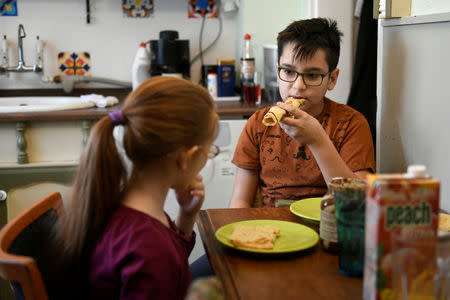 Liza Ludmann-Vank's children eat pancakes for breakfast on the outskirts of Budapest, Hungary, February 16, 2019. Picture taken February 16, 2019. REUTERS/Tamas Kaszas
