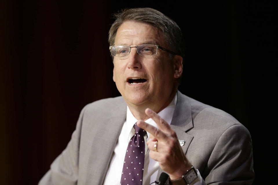 FILE- In this May 4, 2016 file photo, North Carolina Gov. Pat McCrory make remarks concerning House Bill 2 while speaking during a government affairs conference in Raleigh, N.C. Shortly after he signed the law, Republican then-Gov. Pat McCrory issued a statement assuring residents it wouldn't affect North Carolina's status as "one of the top states to do business in the country." The Associated Press has determined that North Carolina's HB2 law will cost the state more than $3 billion in lost business over a dozen years. (AP Photo/Gerry Broome, File)