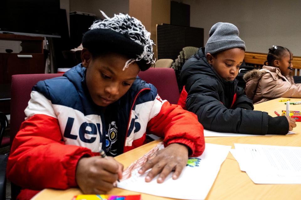 From left: Qa'ree Sanford, 8, and Roshon Williams, 8, color at a table at Creative Visions on Nov. 29, 2023, in Des Moines. The two children are among the many who attend the local nonprofit's after-school programs.