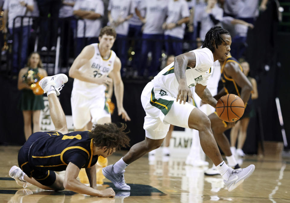 Baylor guard Dantwan Grimes grabs a turnover against John Brown guard Ahlante Askew in the second half of an NCAA college basketball game, Thursday, Nov. 9, 2023, in Waco, Texas. (AP Photo/Rod Aydelotte)