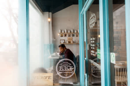 A young man works on Friday afternoon at Adda Coffee & Tea House in Pittsburgh, Pennsylvania, U.S., February 16, 2018. Picture taken February 16, 2018. REUTERS/Maranie Staab