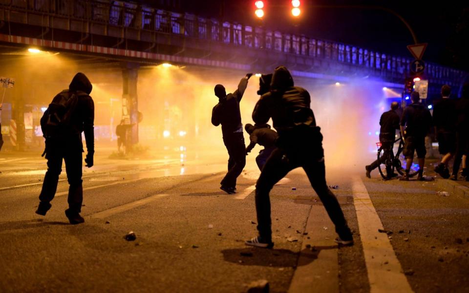 Protesters clash with police during a demonstration ahead of the G20 summit in Hamburg - Credit: EPA