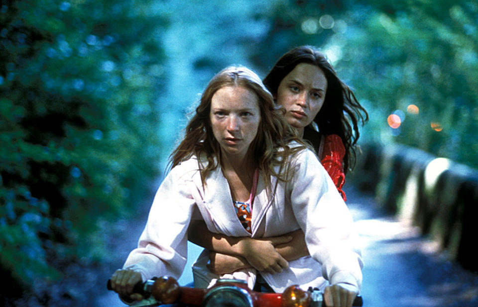 Close-up of Emily sitting on a bike behind another woman