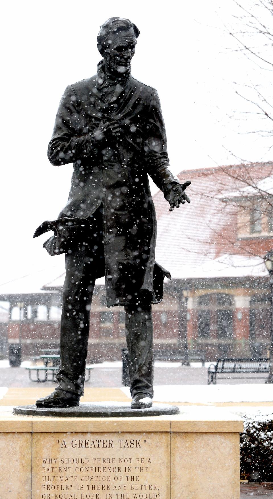 Snowflakes fall on the Abraham Lincoln statue in front of Springfield's Historic Union Station Wednesday.
