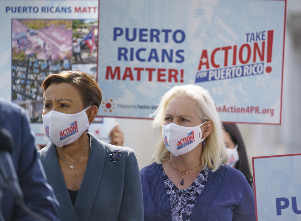 Rep. Nydia Velazquez, D-N.Y., left, and Sen. Kirsten Gillibrand, D-N.Y., join advocates for Puerto Rico which Senate Majority Leader Chuck Schumer, D-N.Y., joins advocates for Puerto Rico, which still suffers from the effects of Hurricane Maria in 2017, at the Capitol in Washington, Monday, Sept. 20, 2021. (AP Photo/J. Scott Applewhite)