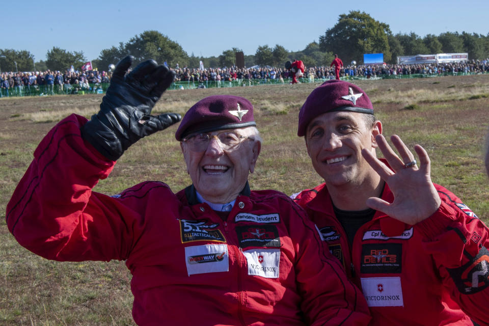 Sandy Cortmann and a member of the Red Devils on the Dropzone at Ginkel Heath, Arnhem, Netherlands. Saturday Sept. 21, 2019. Cortmann, a 97-year-old veteran who served during the Battle of Arnhem in the Second World War, has safely parachuted into the Netherlands today to join commemorations for the 75th anniversary. (Cpl Robert Weideman/MOD via AP)