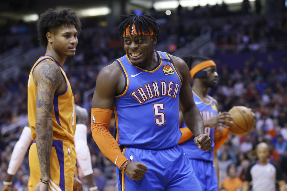Oklahoma City Thunder guard Luguentz Dort (5) shouts after being fouled by Phoenix Suns forward Kelly Oubre Jr., left, as Thunder center Nerlens Noel, right, holds the ball during the first half of an NBA basketball game Friday, Jan. 31, 2020, in Phoenix. (AP Photo/Ross D. Franklin)