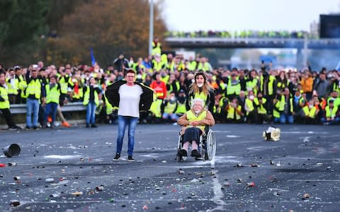Protesters face riot police as they block the A10 motorway in Virsac, near Bordeaux, southwestern France, on November 18, 2018 - Credit: NICOLAS TUCAT/ AFP