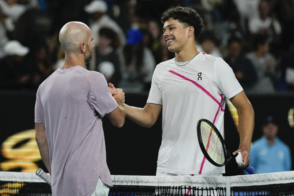 Adrian Mannarino of France is congratulated by Ben Shelton, right, of the U.S. following their third round match at the Australian Open tennis championships at Melbourne Park, Melbourne, Australia, Friday, Jan. 19, 2024. (AP Photo/Louise Delmotte)