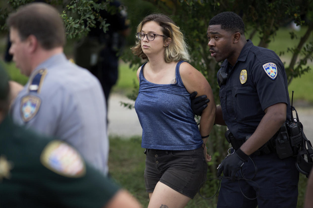 Police arrest protesters after dispersing crowds in a residential neighborhood in Baton Rouge, La. on Sunday, July 10, 2016. After an organized protest in downtown Baton Rouge protesters wondered into residential neighborhoods and toward a major highway that caused the police to respond by arresting protesters that refused to disperse. (AP Photo/Max Becherer)