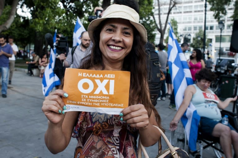 A woman celebrates at Klafthmonos Square in Athens after initial Greek referendum results show a 'No' majority