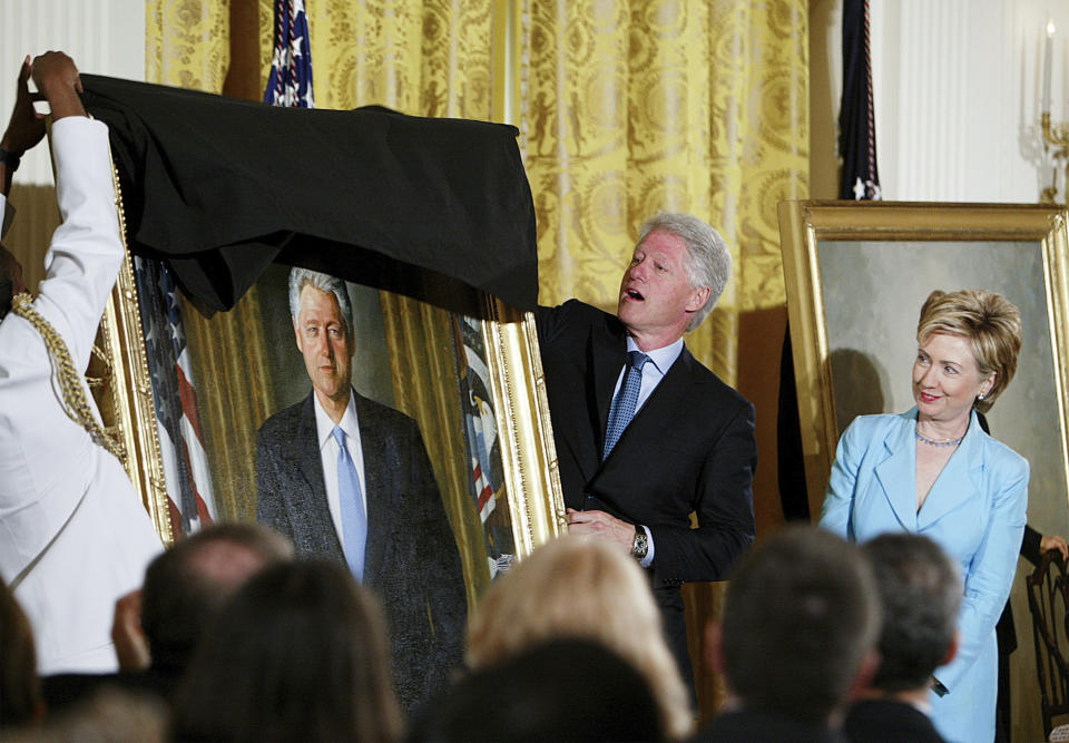 FILE - Former President Clinton, center, unveils his portrait as he and former first lady Hillary Clinton, right, participate in a ceremony for the unveiling of the Clinton portraits, June 14, 2004, in the East Room of the White House in Washington. (AP Photo/Ron Edmonds, File)