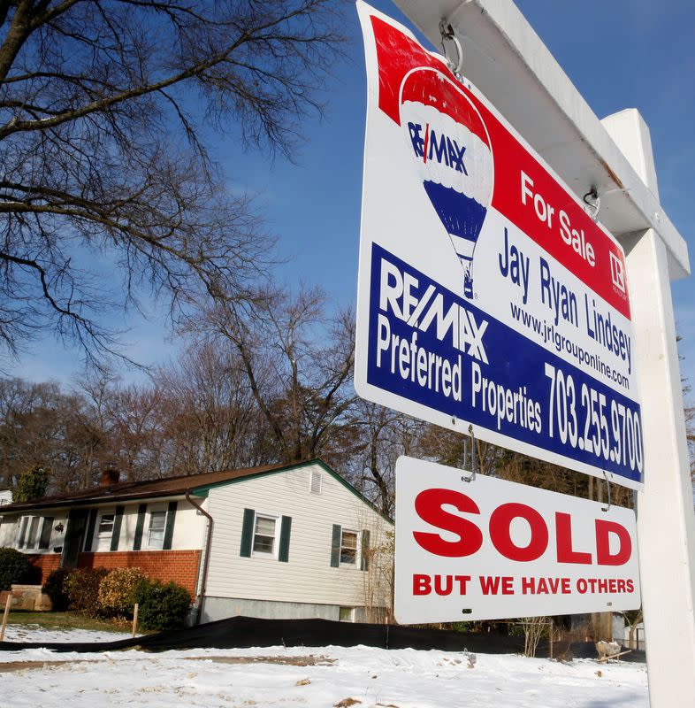 FILE PHOTO: A "SOLD" sign hangs in front of a house in Vienna, on the day the National Association of Realtors issues its Pending Home Sales for February report, in Virginia