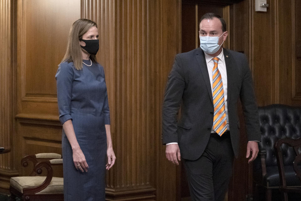 In this Sept. 29, 2020, photo, Judge Amy Coney Barrett, President Donald Trump's nominee to the Supreme Court, meets with Sen. Mike Lee, R-Utah, at the Capitol in Washington. Hours after President Donald Trump announced he had tested positive for the coronavirus, Lee revealed he too had been infected with the disease. (Stefani Reynolds/Pool via AP, File)