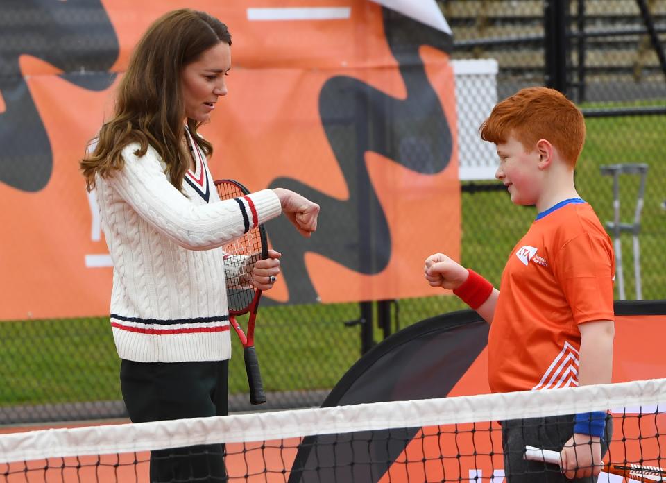 EDINBURGH, SCOTLAND - MAY 27: Catherine, Duchess of Cambridge fist bumps a schoolchild during a tennis game as they take part in the Lawn Tennis Association's (LTA) Youth programme, at Craiglockhart Tennis Centre on May 26, 2021 in Edinburgh, Scotland. (Photo by Andy Buchanan - WPA Pool/Getty Images)