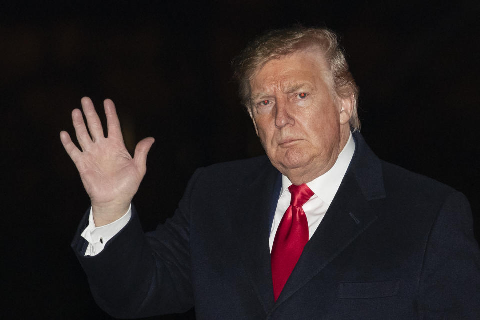 President Donald Trump waves upon his arrival back to the White House in Washington on Sunday, Jan. 19, 2020. (AP Photo/Manuel Balce Ceneta)