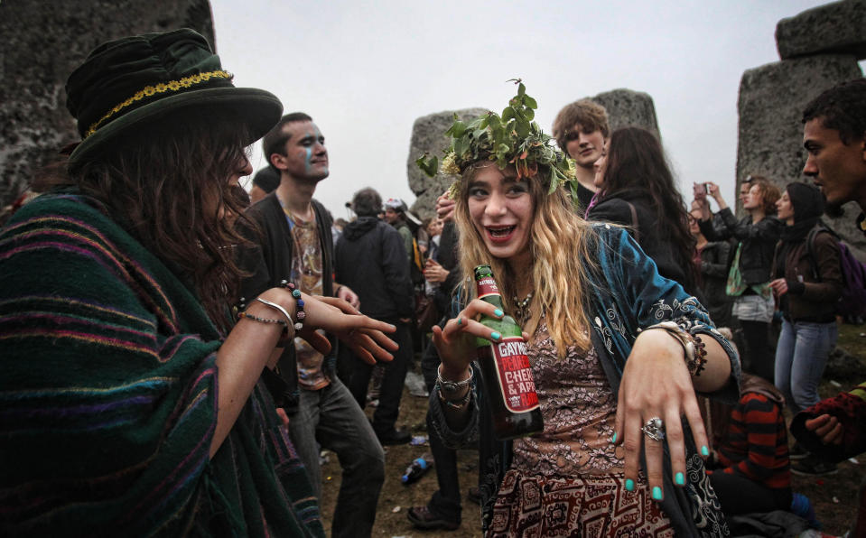 Crowds gather at dawn amongst the stones at Stonehenge in Wiltshire for the Summer Solstice.