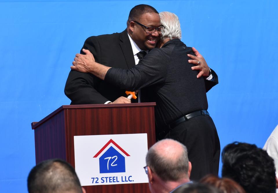 Aliquippa Mayor Dwan Walker hugs developer Chuck Betters at a 72 Steel groundbreaking ceremony.