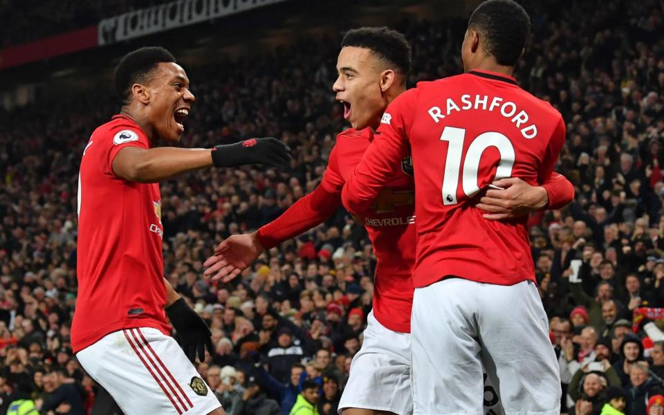 Mason Greenwood (C) celebrates with Manchester United's French striker Anthony Martial (L) and Manchester United's English striker Marcus Rashford (R) after scoring their second goal during the English Premier League football match between Manchester United and Newcastle United - GETTY IMAGES