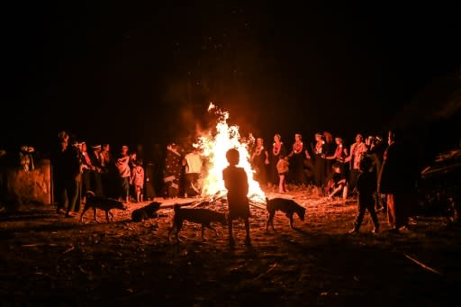 Dressed in black and wearing orange bead necklaces and palm leaf headbands, they rotate around a fire in Satpalaw Shaung village, hands held tightly and braving the cold with bare arms