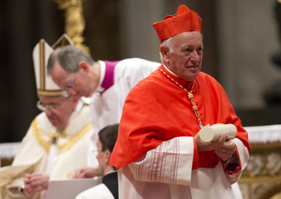 FILE -- In this Saturday, Feb.22, 2014 file photo, newly-elected Cardinal Ricardo Ezzati Andrello, Archbishop of Santiago, Chile, holds his papal Bull of the Creation of Cardinals and wears the red three-cornered biretta hat during a consistory inside the St. Peter's Basilica at the Vatican. Pope Francis has replaced Cardinal Ricardo Ezzati, the embattled archbishop of Santiago, Chile, after he became embroiled in the country's spiraling sex abuse and cover-up scandal. Francis on Saturday, March 23, 2019, accepted Ezzati's resignation and named a temporary replacement to govern Chile's most important archdiocese: the current bishop of Copiapo, Monsignor Celestino Aos Braco. (AP Photo/Alessandra Tarantino, File)