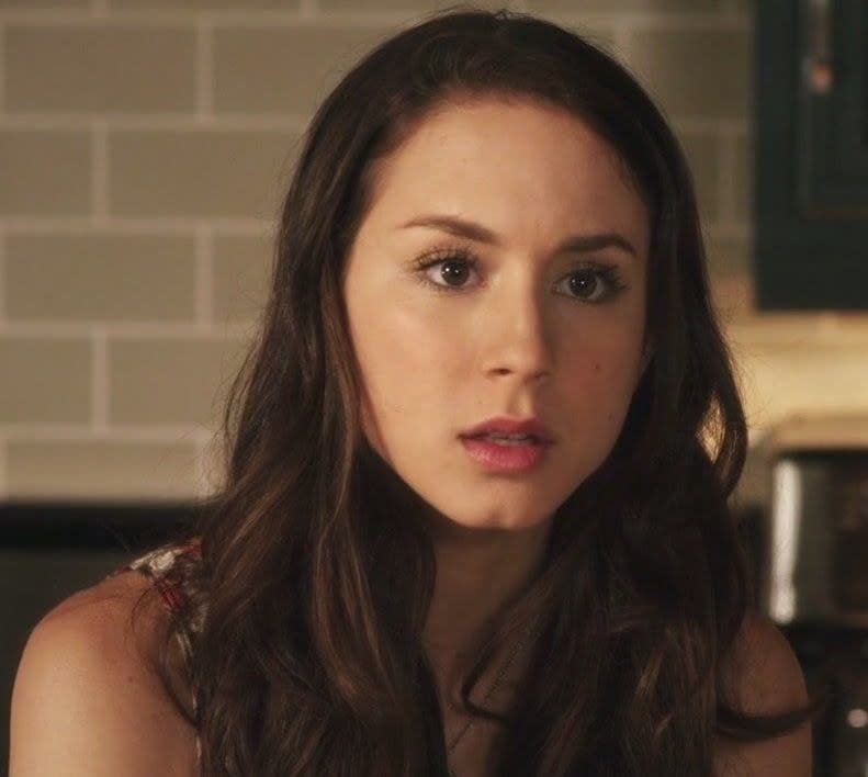 Troian Bellisario with dark har and dark eyes