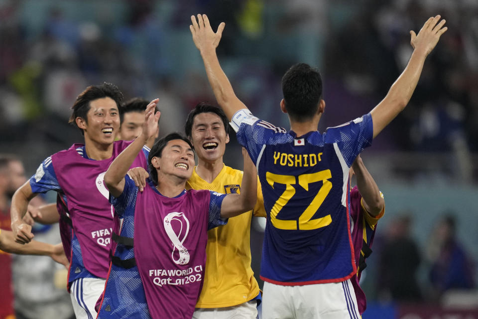 Japan players celebrate after their win in the World Cup group E soccer match between Japan and Spain, at the Khalifa International Stadium in Doha, Qatar, Thursday, Dec. 1, 2022. (AP Photo/Aijaz Rahi)