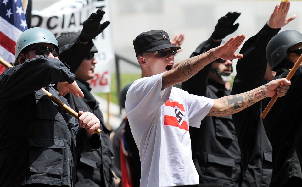 Members of the American National Socialist Movement protest during a rally in front of the Los Angeles City Hall, on April 17, 2010. About 100 members of the self-described neo-Nazi group turned out to protest against immigrants to the United States, sparking a counter-rally that drew about 500 people. The black-clad neo-Nazis were met by members of Hispanic, Black and gay community groups who shouted "Racists Go Home" and "Stop the Nazis." The group requested and received a city parade permit for a white power demonstration at City Hall.