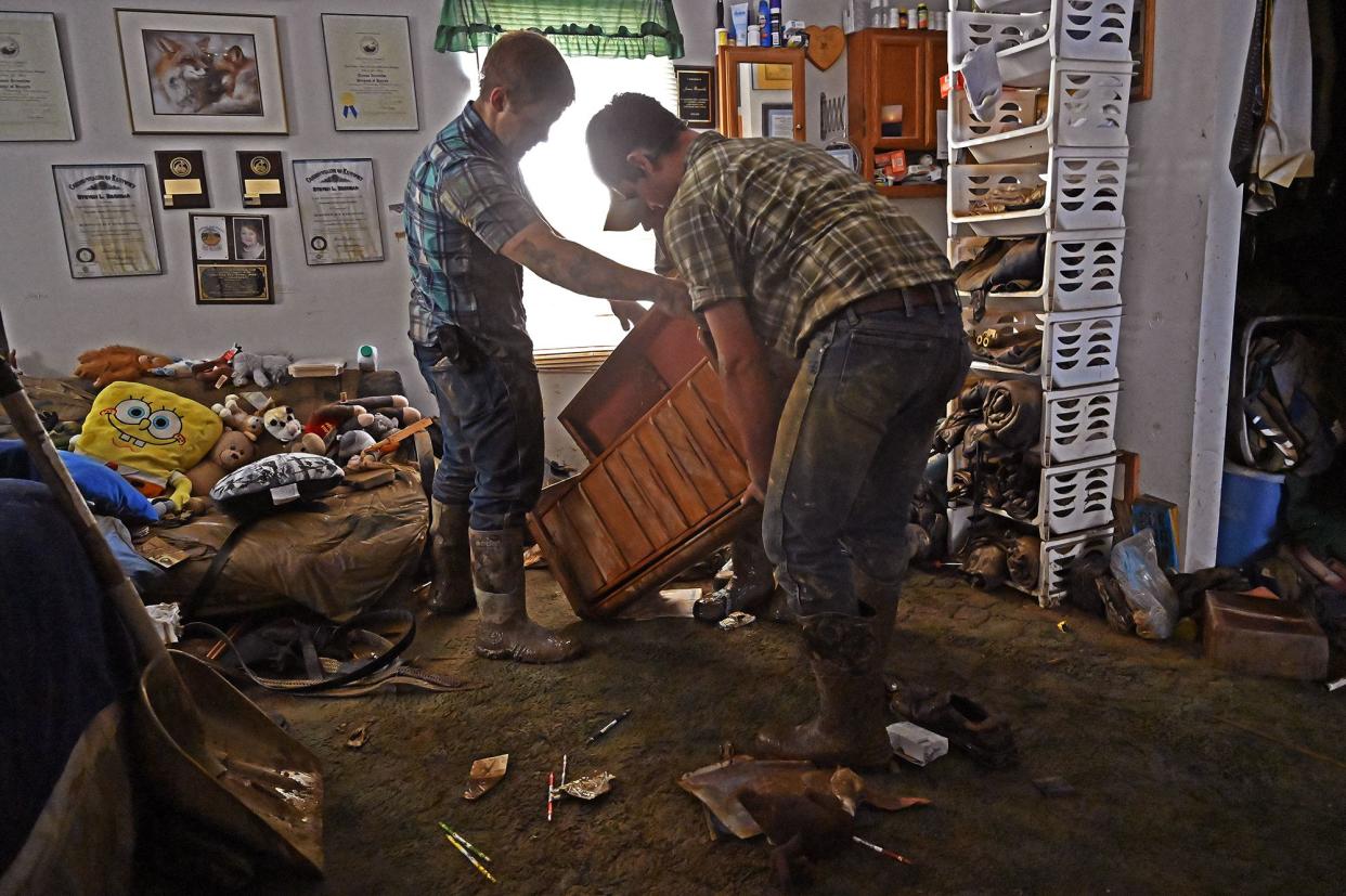 Volunteers from the local mennonite community clean a flood-damaged property from a house at Ogden Hollar in Hindman, Ky. on Saturday, July 30, 2022.