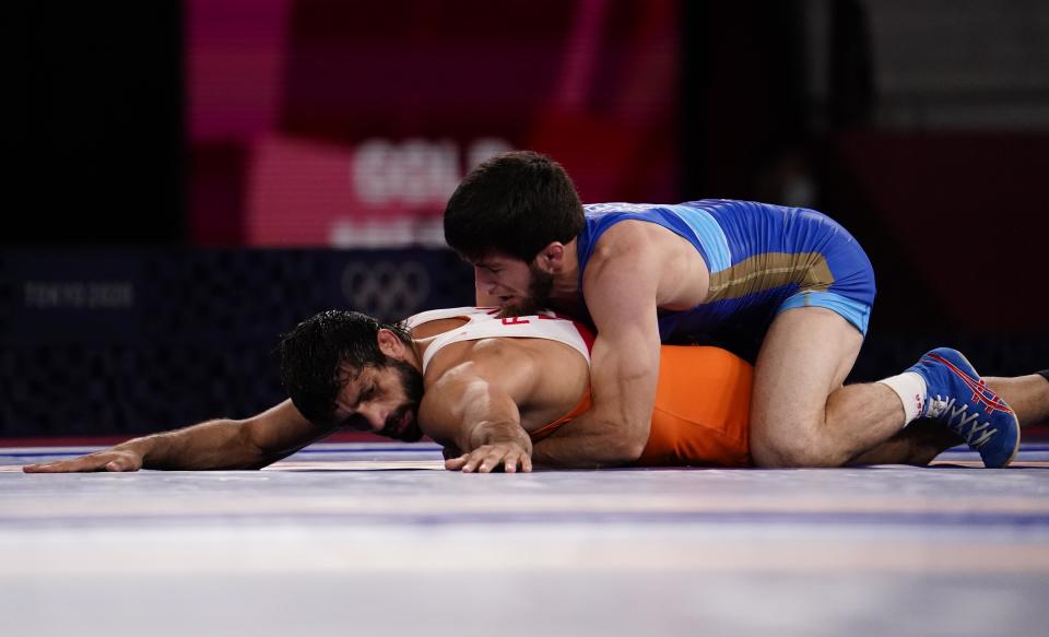 Aug 5, 2021; Chiba, Japan;  Zavur Uguev (ROC) defeats Kumar Ravi (IND) in the men's freestyle 57kg final during the Tokyo 2020 Olympic Summer Games at Makuhari Messe Hall A. Mandatory Credit: Mandi Wright-USA TODAY Sports