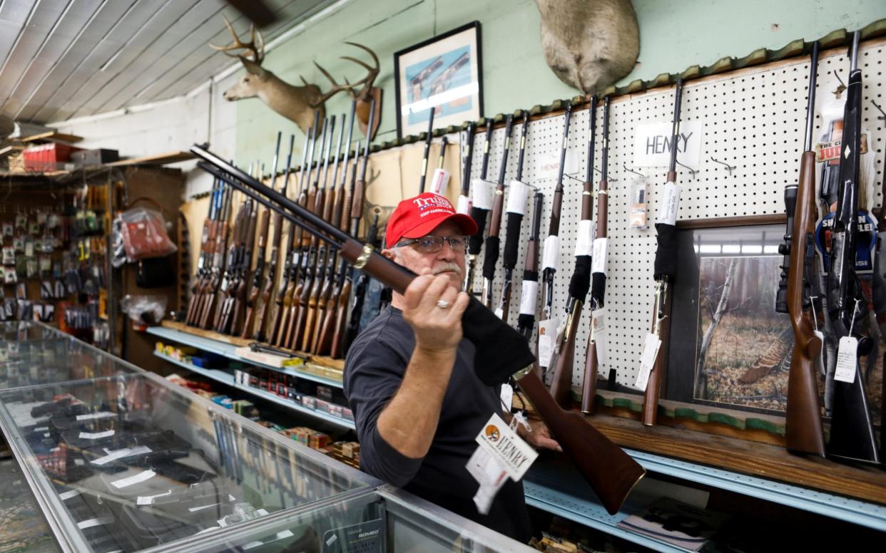 Richard Albrecht, a sales associate at at Nordic Gun & Pawn - Octtavio Jones/Reuters