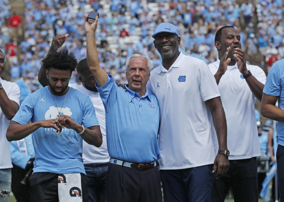 Roy Williams, center, says college basketball’s sneaker underworld is “foreign to me.” (AP)