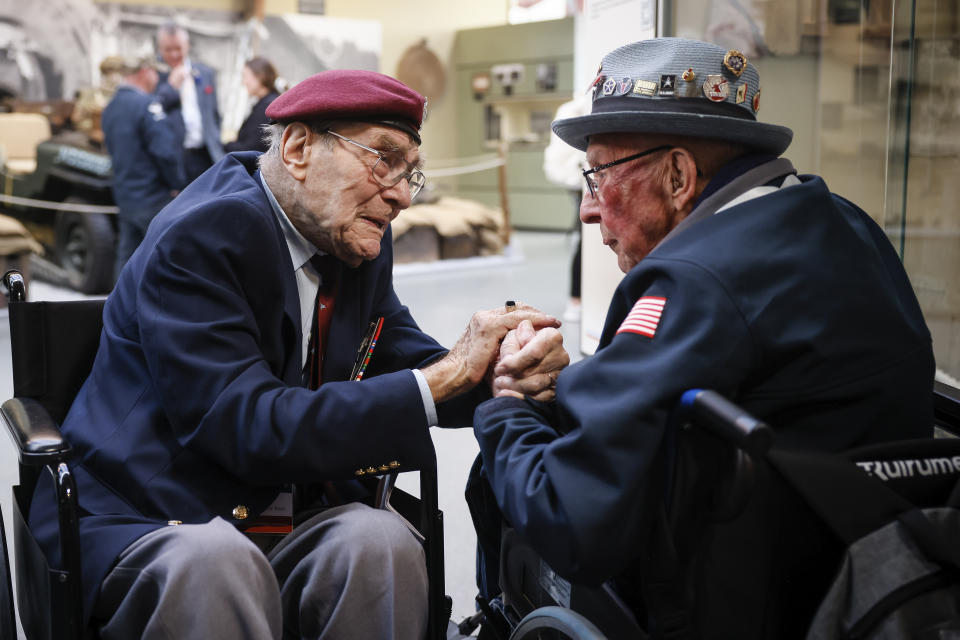 FILE - World War II veteran Britain's Bill Gladden, left, speaks with U.S WWII veteran Jack M. Larson in the Pegasus Bridge memorial in Benouville, Normandy, Monday June 5, 2023. Gladden, one of the dwindling number of veterans who took part in the landings that kicked off the campaign to liberate Western Europe from the Nazis during World War II, died Wednesday, April 24, 2024, his family said. He was 100. (AP Photo/Thomas Padilla, File)