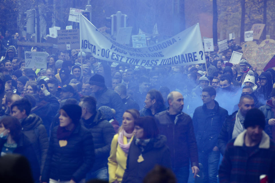 Protestors attend a demonstration against the reinforced measures of the Belgium government to counter the latest spike of the coronavirus in Brussels, Belgium, Sunday, Nov. 21, 2021. Many among them also protested against the strong advice to get vaccinated and any moves to impose mandatory shots. (AP Photo/Olivier Matthys)