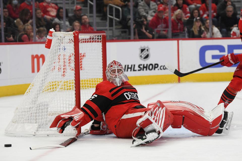 Detroit Red Wings goalie Magnus Hellberg (45) loses his stick and falls backwards after blocking a shot against Ottawa Senators in the first period at Little Caesars Arena in Detroit on Saturday, Dec. 31, 2022.