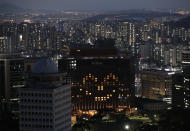 Lighted rooms at the Millennium Hilton hotel show in the shape of a smiley face to send messages of hope to the people amid the coronavirus outbreak in Seoul, South Korea, Sunday, April 26, 2020. (AP Photo/Lee Jin-man)