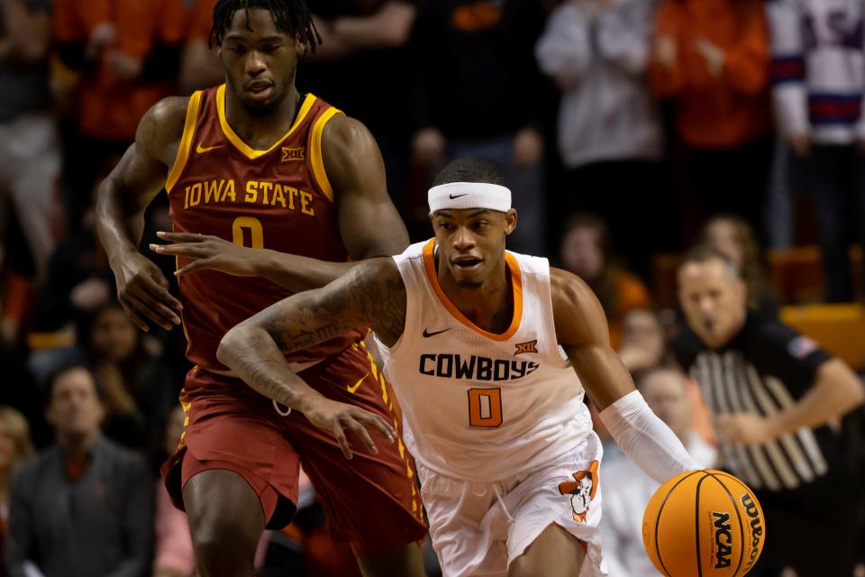 Oklahoma State's Avery Anderson III (0) drives the ball past Iowa State's Tre King (0) in the first half of the NCAA college basketball game in Stillwater, Okla., Saturday, Jan. 21, 2023.