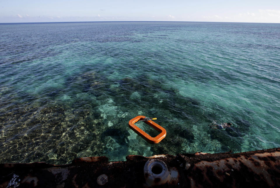 FILE - A Philippine Marine, right, swims in the waters of Second Thomas Shoal in the South China Sea, on March 30, 2014. A Chinese vessel and a Philippine supply ship collided near the disputed Spratly Islands in the South China Sea on Monday, June 17, 2024, China’s coast guard said. (AP Photo/Bullit Marquez, File)