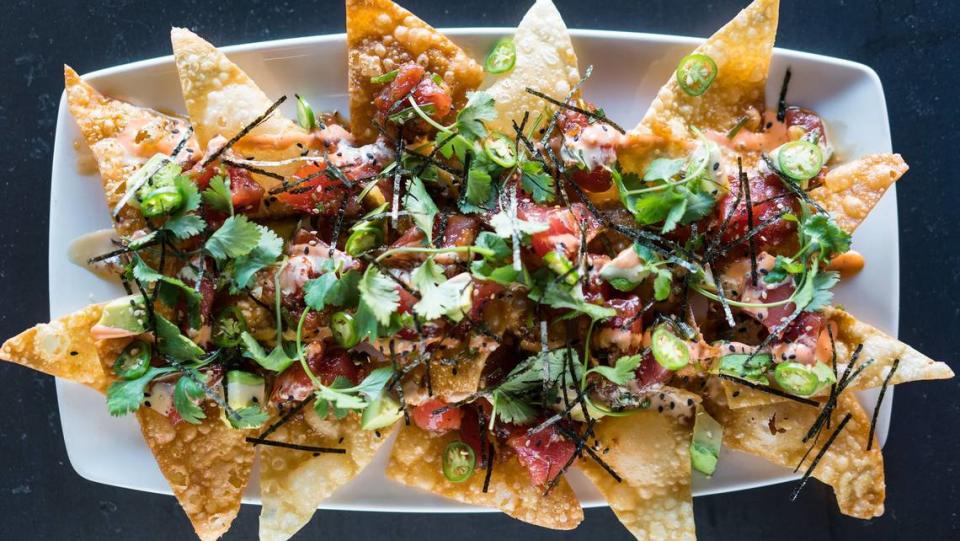 Yard House, known for having more than 100 beers on tap,  along with craft cocktails, tacos, burgers, seafood and steaks, served with a helping of rock music, opened Sunday at University Town Center. Shown above is the Yard House Poke Nachos.