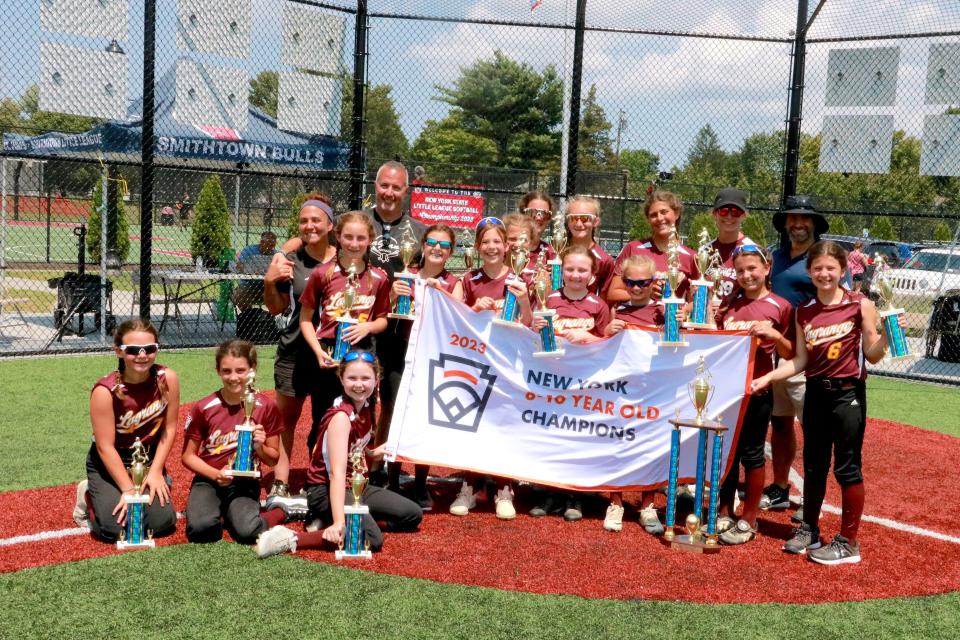 The LaGrange 10-and-under All-Star softball team poses with its banner after winning the New York championship on July 25 on Long Island. The roster includes Anabelle Agosta, Amelia Bennett, Gianna Bliss, Leah Darrrow, Julia DeVico, Aliyah Diaz, Lilly Donnelly, Emily Howard, Meghan LaRose, Abbie McCartney, Avery Patterson, Taylor Perpetua, Willow Velilla and Hannah Warner.
