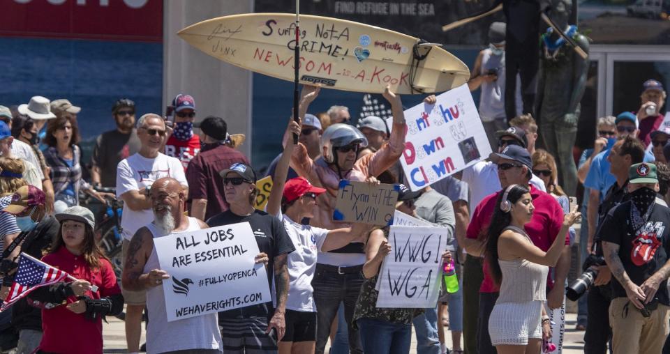 Thousands of protesters rally at Main Street and Pacific Coast Highway in Huntington Beach on May 1.