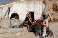 Saliha Mohamedi, 36, talks with her daughters after finishing her housework, outside of her troglodyte house on the outskirts of Matmata, Tunisia, February 5, 2018. REUTERS/Zohra Bensemra