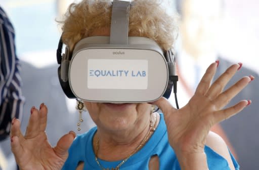 Nidia Silva samples a virtual reality experience in the Little Havana neighborhood of Miami, Florida