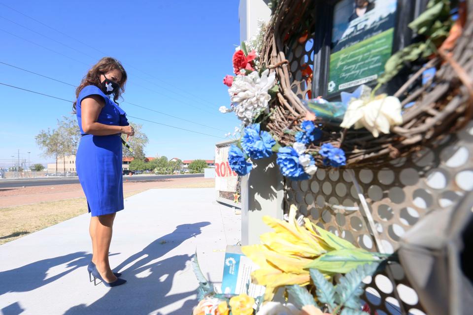 U.S. Rep. Veronica Escobar, D-El Paso, places flowers at Ponder Park on the one-year anniversary of the Walmart mass shooting Monday, Aug. 3, 2020, in El Paso.