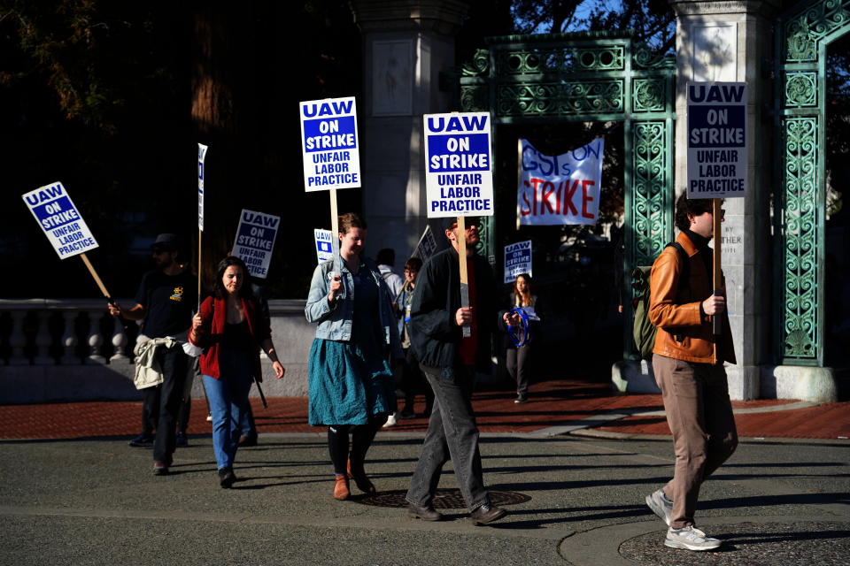 Graduate student instructors and researchers picket at University of California, Berkeley's Sather Gate during the fourth week of a strike by academic workers at the 10-campus UC system in Berkeley, Calif., Wednesday, Dec. 7, 2022. A month into the nation's largest strike involving higher education, classes are being cancelled and important research is being disrupted at the 10 campuses of the University of California. (AP Photo/Terry Chea)