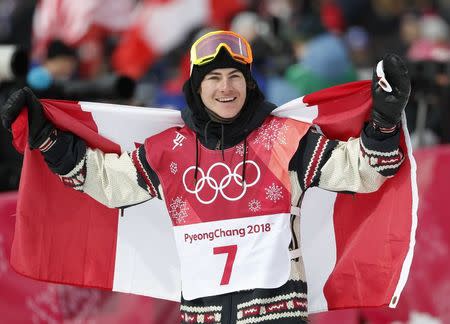 Snowboarding - Pyeongchang 2018 Winter Olympics - Men's Big Air Finals - Alpensia Ski Jumping Centre - Pyeongchang, South Korea - February 24, 2018 - Sebastien Toutant of Canada celebrates with his national flag. REUTERS/Murad Sezer